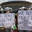 Activists demonstrate in front of riot police outside the Mane Garrincha National Stadium in Brasilia